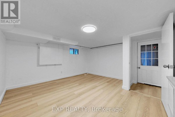 Empty room with beige tile flooring and recessed lighting - Bsmt - 858 Manning Avenue, Toronto