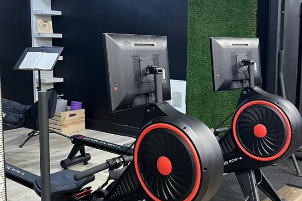 Two rowing machines with monitors and stands for tablets or notes in a gym. - Bsmt - 860 North Park Drive, Brampton