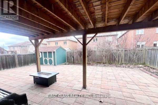 Covered patio with stone pavers and a fire pit overlooking a fenced backyard. - Bsmt - 9 Wiley Avenue, Richmond Hill