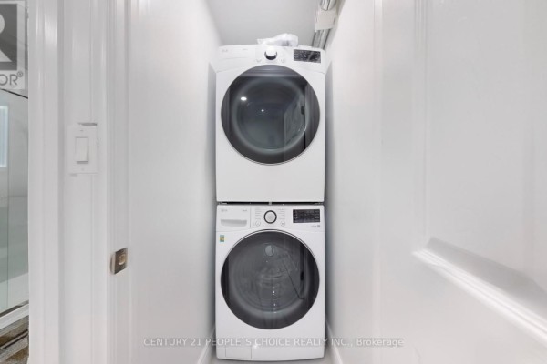 Stacked white LG washing machine and dryer in a small white room with white doors. - Bsmt 2 - 26 Lyle Way, Brampton