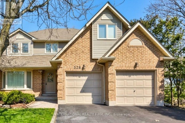 Front exterior of a two-story brick house with a double garage, numbered 528. - Bsmtapt - 328 Sheppard Avenue, Pickering