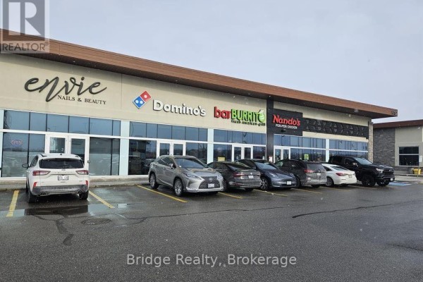 Wide storefront view featuring Envie Nails & Beauty, Domino's, Bar Burrito, and Nando's. - Building 4 - 1782 Stonechurch Road E, Hamilton