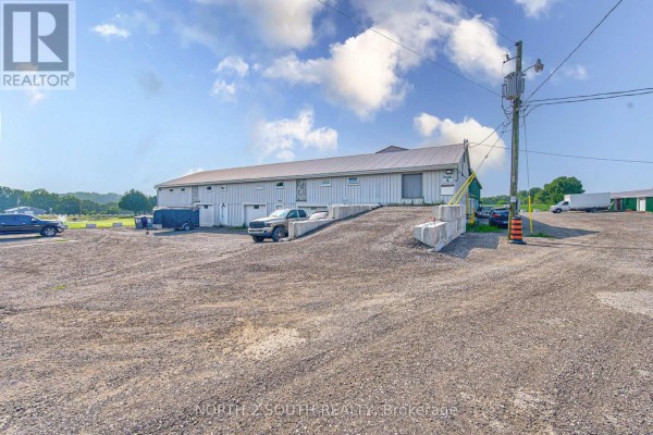 Commercial building exterior with a ramp and pickup truck. - Building 4 Upper #1 & #2 - 428 Lynden Road, Brantford