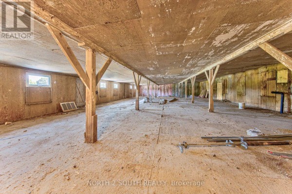 Interior of a large empty commercial space with wooden beams and walls. - Building 4 Upper #1 & #2 - 428 Lynden Road, Brantford