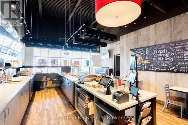 Long service counter with POS systems, menu boards, and windows overlooking the exterior. - Building C, Unit #4a - 130 Atherley Rd Road, Orillia