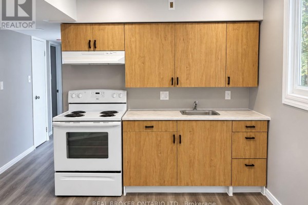 Compact kitchen with light wood laminate cabinets, white appliances, and light grey countertops. - C - 93 Brybeck Crescent, Kitchener