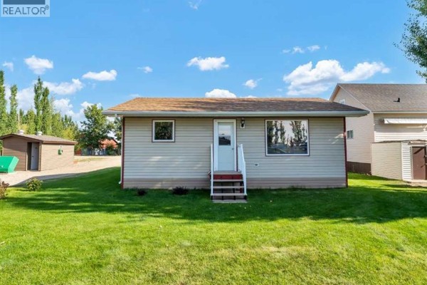 Open living and dining space with leather seating, wood paneling, and a patterned area rug. - C47 Forty Mile Park, Rural Forty Mile No  8, County Of