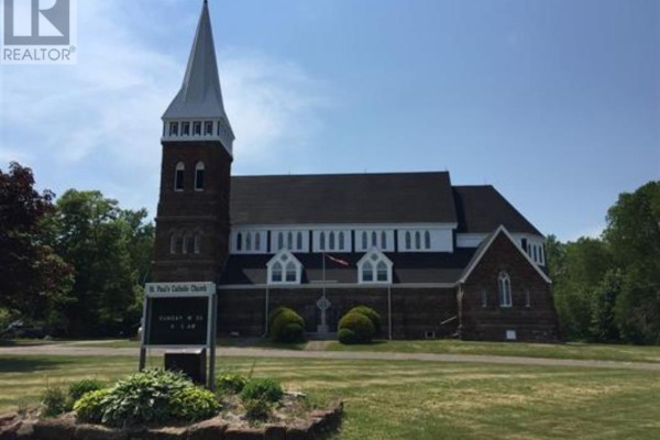A large, red brick church with a tall steeple and white trim against a blue sky. - Cambridge Road, Sturgeon