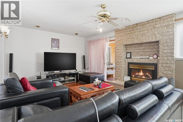 Living room showing a large television, fireplace, and seating area. - Chamberlain Acreage 3, Chamberlain