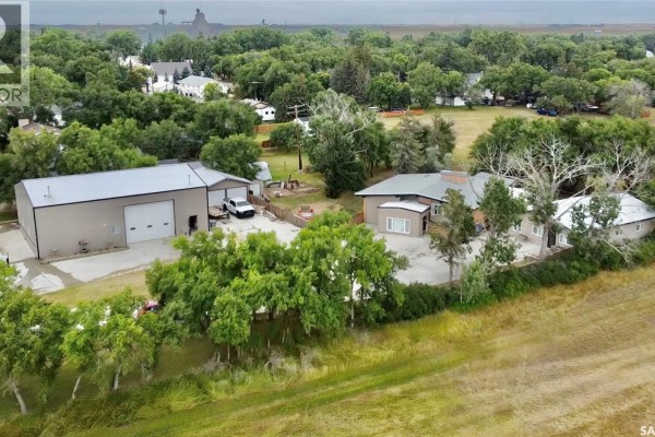 Aerial view of the property featuring a large shop and residential house. - Chaplin Acreage - Two Houses And Large Shop, Chaplin
