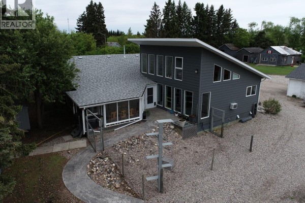 Close-up aerial view of the modern grey house featuring large windows and an angled roof. - Codette Acreage, Nipawin Rm No  487