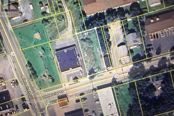 Another angle of the vacant lot with nearby buildings visible. - Commercial St Dominion Land, Dominion