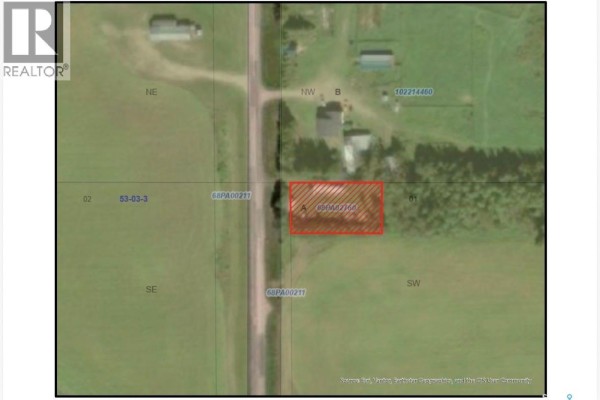 Compact kitchen in a mobile home with wooden cabinets, white refrigerator, and white stove. - Cookson Acreage, Shellbrook Rm No  493