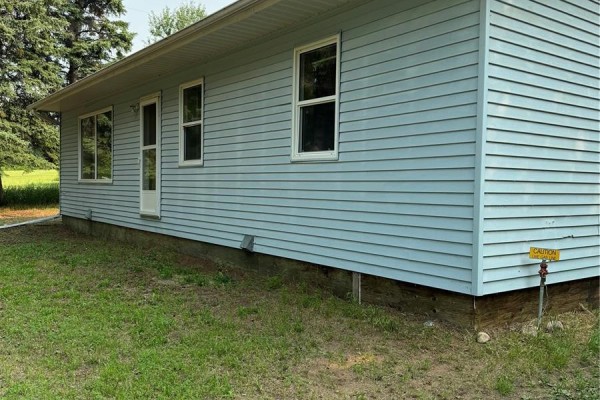Kitchen with wood cabinets, stainless steel stove, and double sink. - Crystal Lake Jewel, Crystal Lake