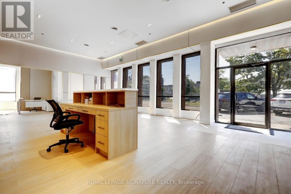 Office space with a dark wood desk, mesh chair, marble and wood accent walls. - D - 310 Steelcase Road E, Markham
