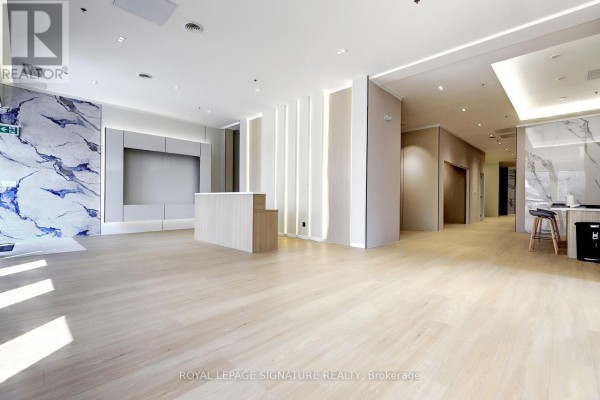 Round marble-topped table with a lazy Susan and upholstered chairs in a finished room. - D - 310 Steelcase Road E, Markham