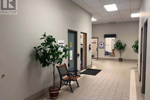 Interior hallway with tiled floor, chairs, plants, and doors leading to different offices. - D - 71 Bolton Street, Kawartha Lakes
