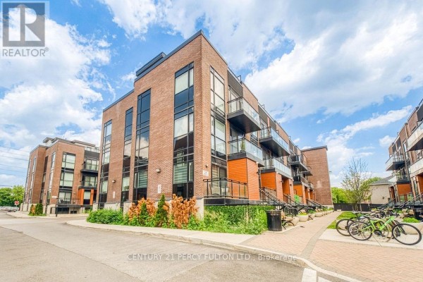 View of the townhouse exterior with balconies and large windows. - D-803 - 5289 Highway 7, Vaughan