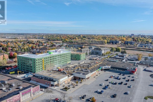 Aerial view of commercial development including a green-clad building under construction. - D1 - 1300 Bath Road, Kingston