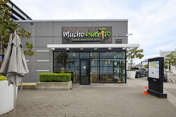 Close-up of the Mucho Burrito storefront with glass entrance doors and windows. - D130 3122 Mt. Lehman Road, Abbotsford