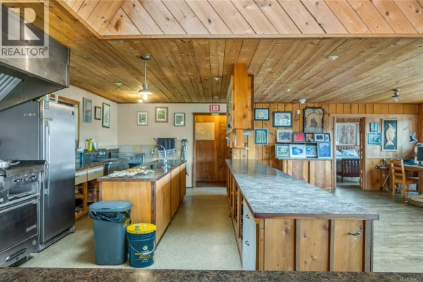 Interior view of kitchen area featuring wooden cabinetry, granite countertops, and dining space. - Dl1489 Jackson Bay, See Remarks