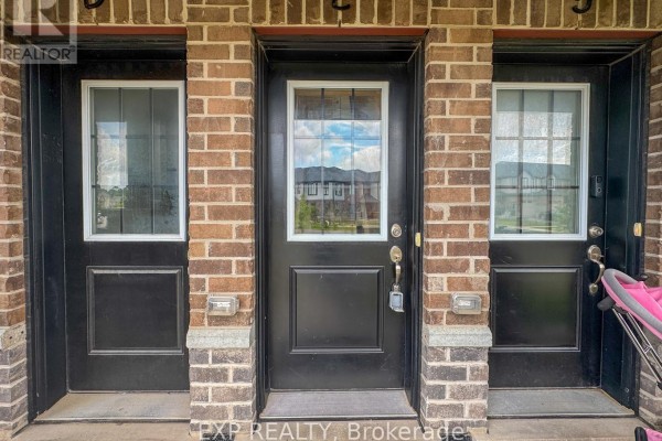 Close-up of three townhouse entrances with black doors, windows, and brick exteriors. - E - 150 Rochefort Street, Kitchener