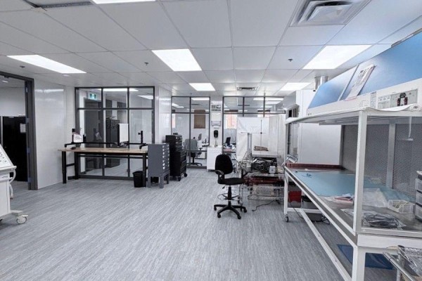 Spacious office or lab area with desks, equipment, glass-partitioned offices, and lighting. - Entire Building - 139 Mulock Avenue, Toronto