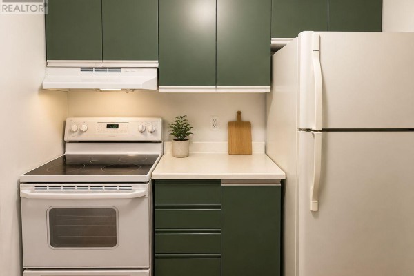 Kitchenette with white appliances, dark green cabinets, and a white countertop. - F8 - 171 Edgehill Drive, Barrie