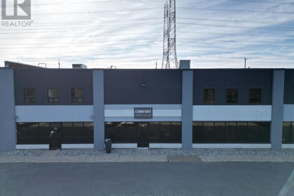 Front facade of a commercial building with dark grey metal siding and large windows. - G-h - 60 Colonnade Road, Ottawa