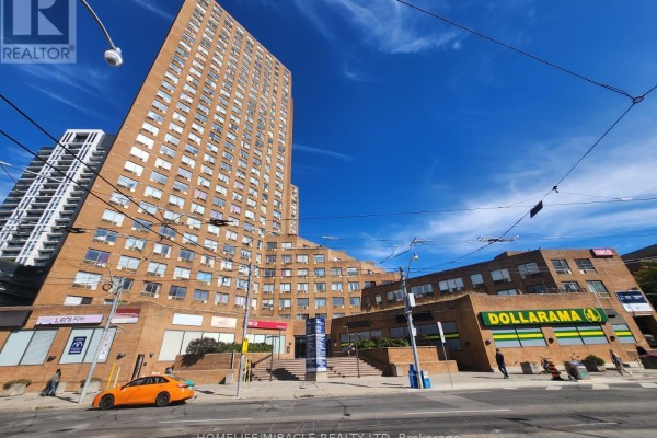Street view of a brick building complex with Dollarama and residential units. - G11 - 2340 Dundas Street W, Toronto