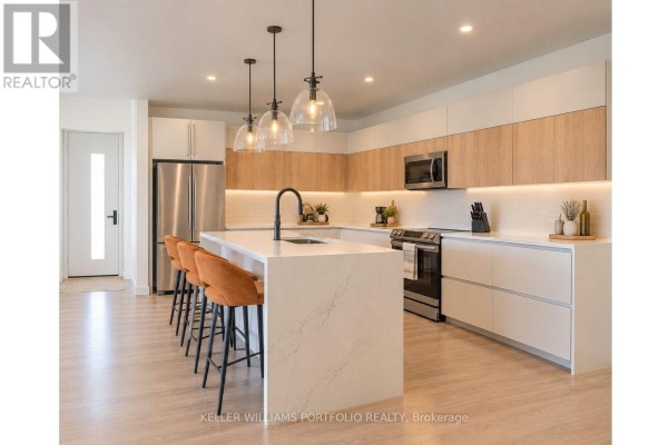 Open-concept kitchen featuring a large island with seating, white countertops, and two-tone cabinetry. - Garden Residence - Sugar Ridge Condos Valley Road, Antigua