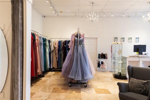 Another view of the boutique showcasing formal dresses on racks. - G&h 197 Main Street, Steinbach