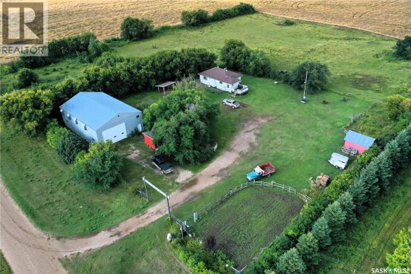 Aerial view of Grandfield Acreage with houses, barn, pens, and fields. - Grandfield Acreage, Nipawin Rm No  487