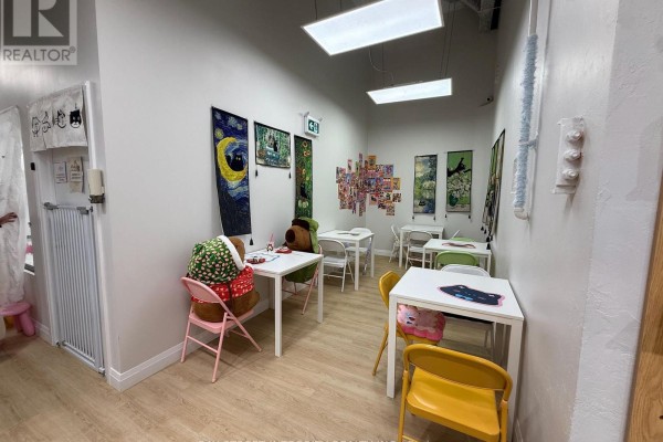 Interior view of a cat cafe with multiple levels of cat trees, climbing structures, and cats. - Ground - 327 - 333 Queen Street W, Toronto