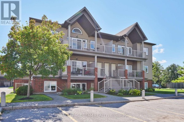 Close-up of the brick exterior and lower-level windows of an apartment building. - H - 105 Fraser Fields Way, Ottawa