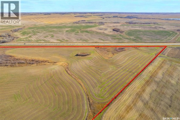 Aerial view of a large farm property outlined in red, showcasing cultivated fields and a highway. - Highway #41 Farm Land, Corman Park Rm No  344