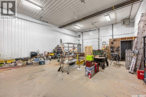 Interior of commercial bay with concrete floor, white metal walls, and various equipment. - Hwy 11 Bays, Lumsden Rm No  189
