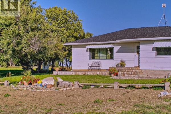 White barn on a harvested field under a clear blue sky. - Imlach Acreage, St  Andrews Rm No  287