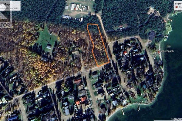 Aerial view of a wooded property lot bordered by roads and a lake with houses. - K Cottage Road, Turtle Lake