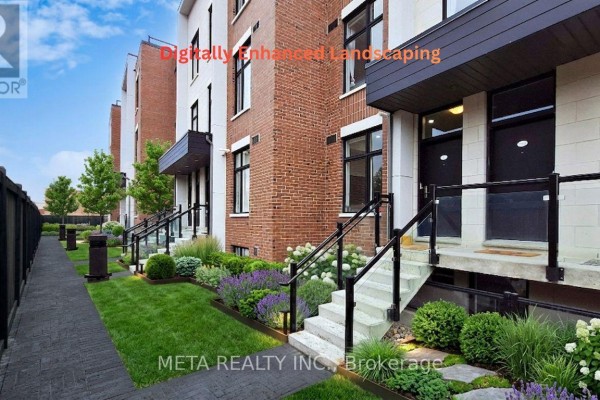 Front entrance of a townhouse with brick and stone exterior, green lawn, and shrubs. - L144 - 9560 Islington Avenue, Vaughan