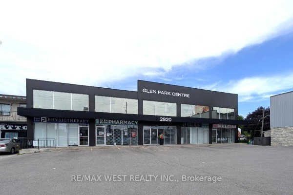 Front facade of Glen Park Centre building with large windows and signage for various businesses. - Ll1 - 2920 Dufferin Street, Toronto