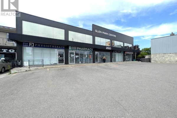 Close-up exterior view of the commercial building's physiotherapy and pharmacy storefronts. - Ll2 - 2920 Dufferin Street, Toronto