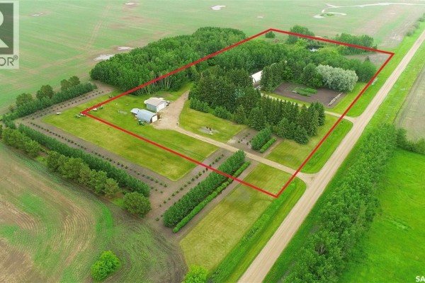 Aerial view of property showing log home, garden plot, and surrounding trees. - Log Acreage In Rm Of Torch River, Torch River Rm No  488