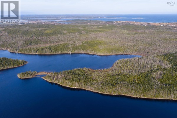 Aerial view shows a wooded peninsula on a large, dark blue lake with distant land visible. - Long Pt Seaforth, Ns, Seaforth