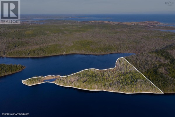 Aerial view highlights a wooded peninsula on the lake with white lines marking approximate property boundaries. - Long Pt Seaforth, Ns, Seaforth