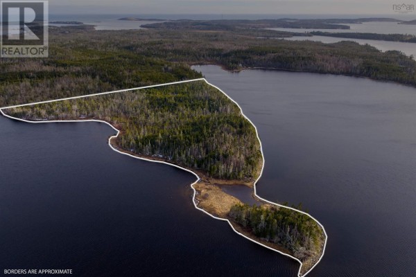 Aerial shot of the wooded peninsula on the lake, showing property boundaries and surrounding water. - Long Pt Seaforth, Ns, Seaforth