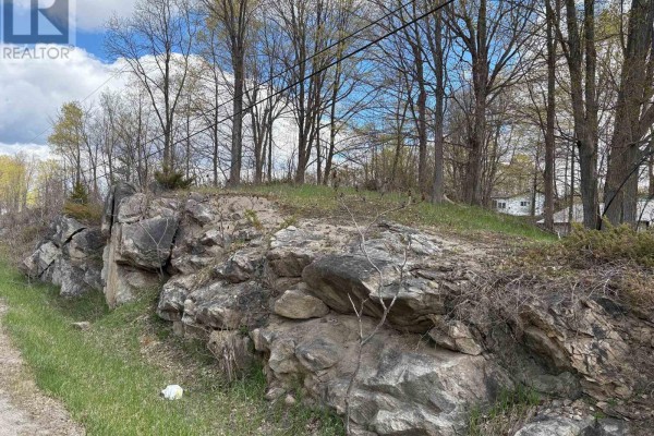 Rocky edge of the property with snow and utility lines visible - Lot 0 County Road 38, Frontenac