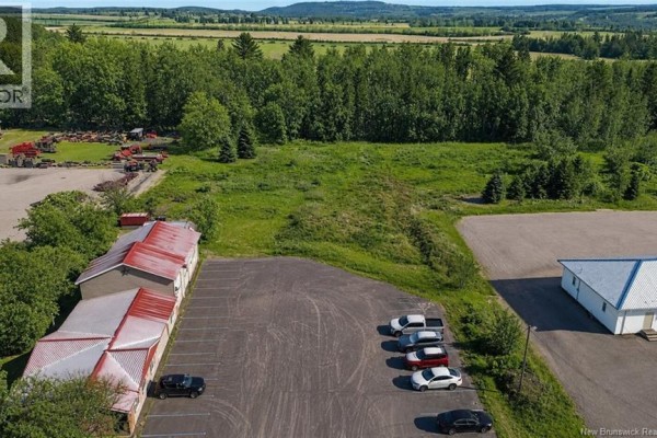 View of partially cleared land with red-roofed buildings and scattered trees in a winter landscape. - Lot 06-1 Burnham Road, Florenceville Bristol