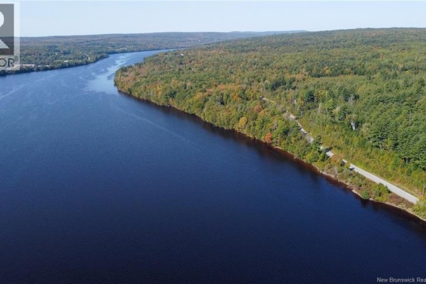 Aerial view of a wide river bordered by autumnal trees and a road. - Lot 09-01 Route 105, Southampton