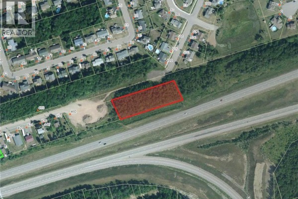 Aerial view of Lot 1 Highlandview Road, Moncton, a wooded area next to a highway and residential neighbourhood. - Lot 1 Highlandview Road, Moncton